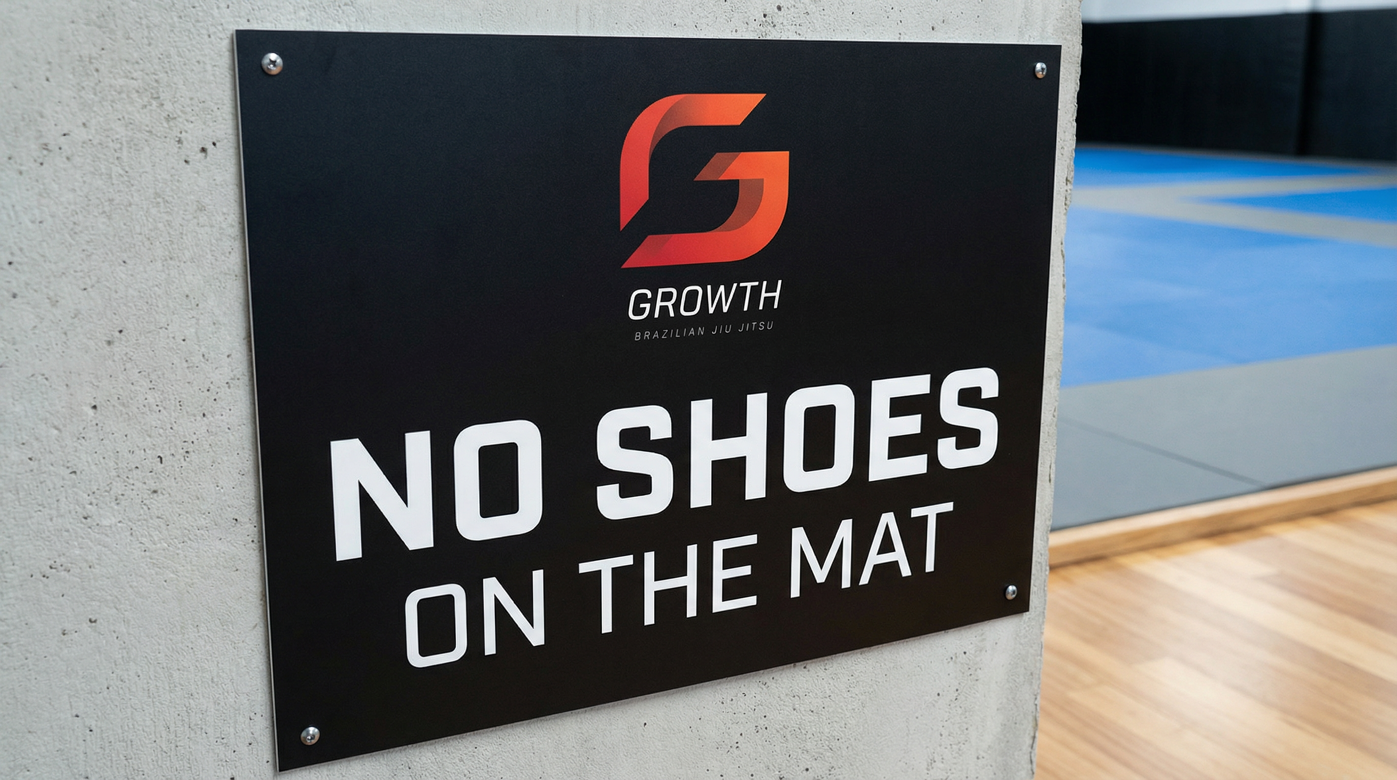 Growth BJJ no shoes on the mat signage
